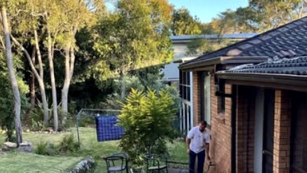 Backyard outdoor area behind a brick home